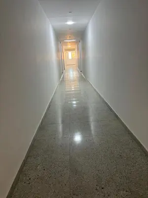 an empty hallway with a white wall and a door at La Prestigia chalet in Hurghada