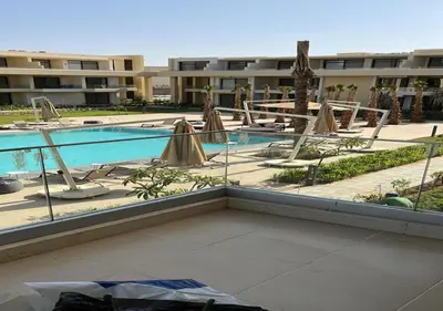 a view of a swimming pool with umbrellas and chairs at Studio at G Cribs B21-F10 El Gouna in Hurghada