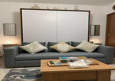 a living room with a blue couch and a coffee table at Studio at G Cribs B21-F10 El Gouna in Hurghada