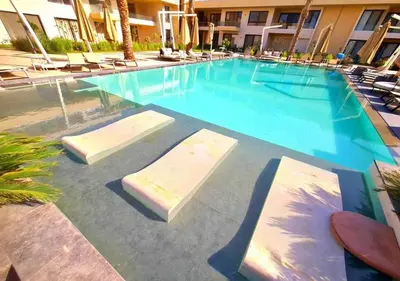 a swimming pool at a hotel with chairs in it at Studio at G Cribs B21-F10 El Gouna in Hurghada