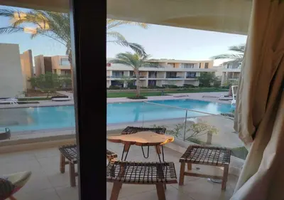a patio with a table and chairs and a pool at Studio at G Cribs B21-F10 El Gouna in Hurghada