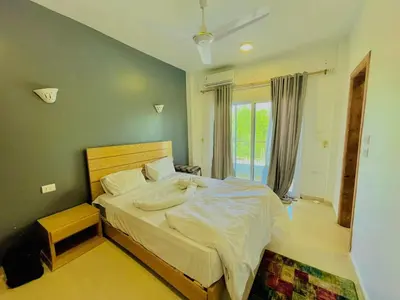 a bedroom with a large bed and a window at Luxor in Al Karnak