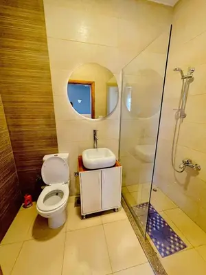 a bathroom with a toilet and a sink and a shower at Luxor in Al Karnak