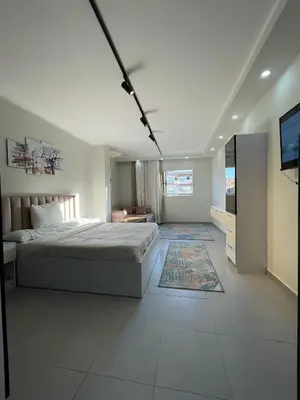 a bedroom with a bed and a television in it at CHALET IN HURGHADA SCANDIC ReSORT in Hurghada