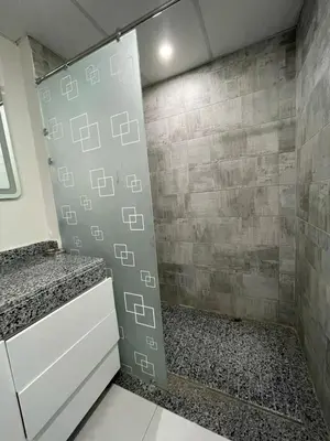 a shower in a bathroom with a tile wall at CHALET IN HURGHADA SCANDIC ReSORT in Hurghada