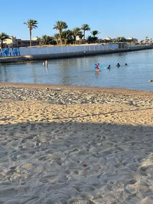 a group of people swimming in a body of water at CHALET IN HURGHADA SCANDIC ReSORT in Hurghada