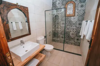 a bathroom with a sink and a toilet and a shower at Sultana Palace in ‘Ezbet Abu Ḥabashi