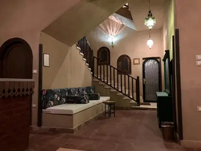 a living room with a couch and a staircase at Sultana Palace in ‘Ezbet Abu Ḥabashi