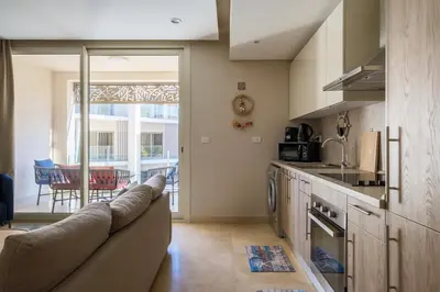 a living room with a couch in a kitchen at Mangroovy 1BR + Sofa bed • Pool & Beach Access in Hurghada