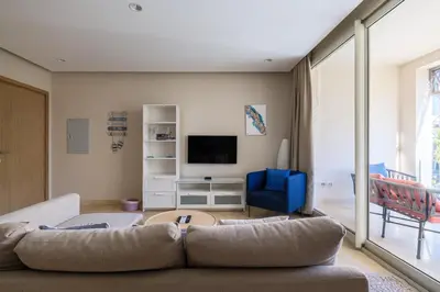 a living room with a couch and a tv at Mangroovy 1BR + Sofa bed • Pool & Beach Access in Hurghada