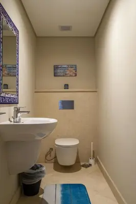 a bathroom with a sink and a toilet and a mirror at Mangroovy 1BR + Sofa bed • Pool & Beach Access in Hurghada
