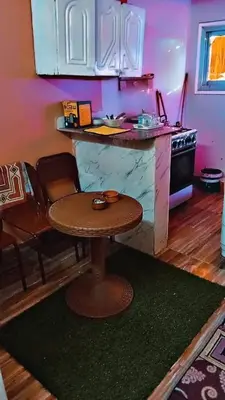 a kitchen with a table and a counter top at البلدوزر وسط البلد شارع كسر الحجر الرئيسي in Aswan