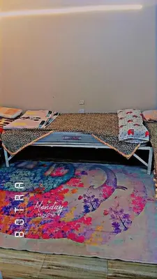 a bed in a room with a rug on the floor at البلدوزر وسط البلد شارع كسر الحجر الرئيسي in Aswan