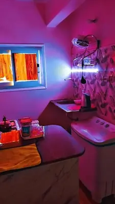 a pink kitchen with a counter and a stove at البلدوزر وسط البلد شارع كسر الحجر الرئيسي in Aswan