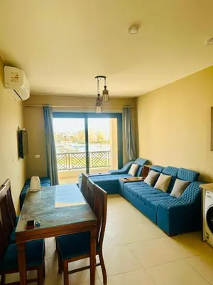 a living room with a blue couch and a table at Luxury Escape in Hurghada, Egypt in Hurghada