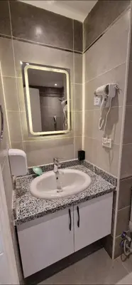 a bathroom with a sink and a mirror at Hurgada New studio in Avenue on Mamsha -private beach&pool in Hurghada