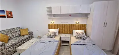a living room with two beds and a couch at Hurgada New studio in Avenue on Mamsha -private beach&pool in Hurghada