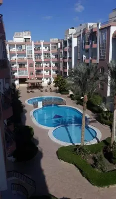 arial view of a swimming pool in front of a building at Desert Pearl luxury apartment in Hurghada