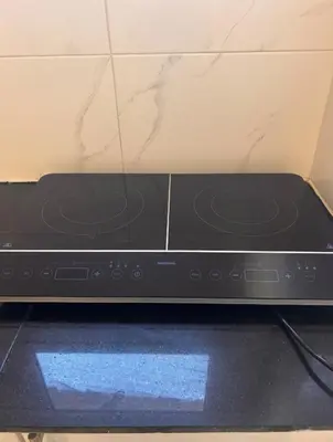 a black microwave oven sitting on top of a counter at Desert Pearl luxury apartment in Hurghada