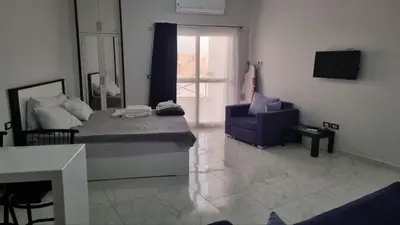 a living room with a couch and a chair at Sunny Studio Tiba View Red Sea in Hurghada