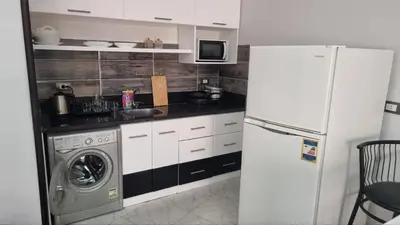 a kitchen with a refrigerator and a washing machine at Sunny Studio Tiba View Red Sea in Hurghada
