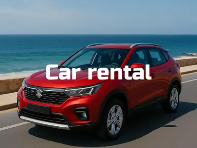 a red car rental sign on a road near the ocean at Sunny Studio Tiba View Red Sea in Hurghada