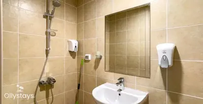 a bathroom with a shower and a sink at Ollystays Mangrovy Seaview Penthouse 3BR Beach & Pool access in Hurghada