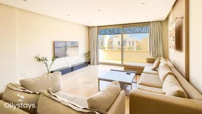 a living room with couches and a table at Ollystays Mangrovy Seaview Penthouse 3BR Beach & Pool access in Hurghada