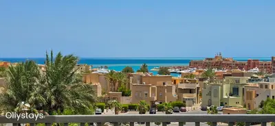 a view of a city with palm trees and buildings at Ollystays Seaview Villa 3BR Heated Pool GYM-Joubal El Gouna in Hurghada