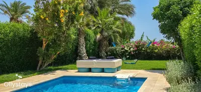 a swimming pool with a hot tub in a yard at Ollystays Seaview Villa 3BR Heated Pool GYM-Joubal El Gouna in Hurghada