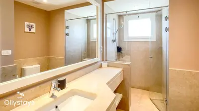 a bathroom with a sink and a shower and a mirror at Ollystays Seaview Villa 3BR Heated Pool GYM-Joubal El Gouna in Hurghada