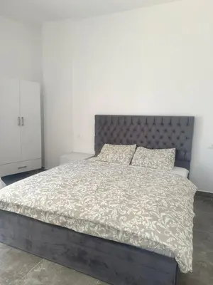 a bedroom with a large bed with a gray headboard at Aqua Infinity in Hurghada