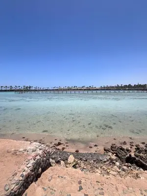 a beach with a pier in the water at Hurghada Tiba Golden Resort Apartment Strand Pool 22 in Hurghada