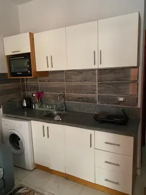 a kitchen with a sink and a washing machine at Tiba view in Hurghada