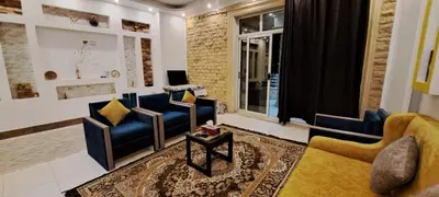 a living room with blue couches and a window at Egypt Soul hotel retreat in Luxor