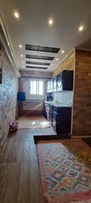 a room with a kitchen with a table and a rug at Egypt Soul hotel retreat in Luxor
