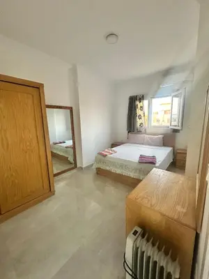 a small bedroom with a bed and a mirror at Bostan in Hurghada