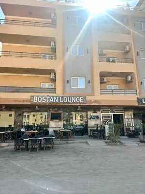 a building with tables and chairs in front of it at Bostan in Hurghada