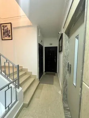 a hallway with stairs and a black door at Bostan in Hurghada