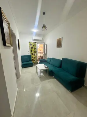 a living room with a green couch and a table at Bostan in Hurghada