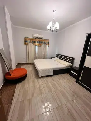 a small room with a bed and a chair at Hurghada Promenade Spacious 1-Bedroom Apartment in Makramia Compound in Hurghada