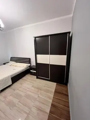 a bedroom with a bed and a large sliding door at Hurghada Promenade Spacious 1-Bedroom Apartment in Makramia Compound in Hurghada
