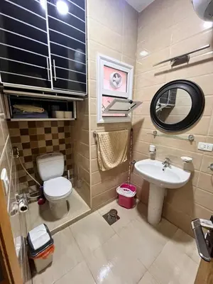 a small bathroom with a toilet and a sink at Hurghada Promenade Spacious 1-Bedroom Apartment in Makramia Compound in Hurghada