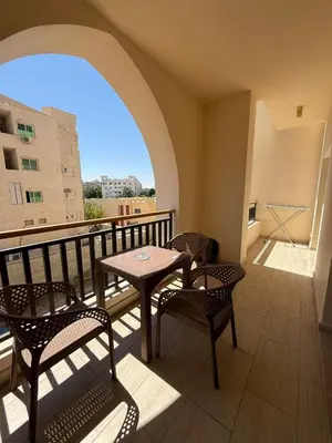 a balcony with a table and chairs on a balcony at Casa bonita in Hurghada