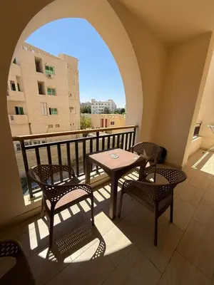a balcony with a table and chairs and a window at Casa bonita in Hurghada