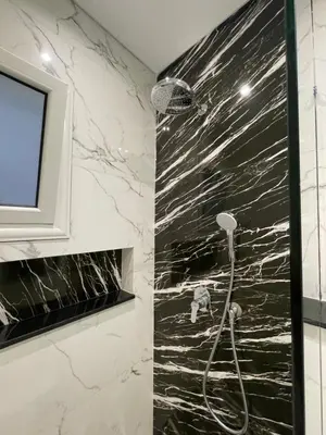 a bathroom with a shower with black and white marble at Endless Summer Apartment House W7 in Safaga