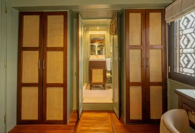 a room with doors and a hallway with a bathroom at HMC Zahra Dahabyia in Luxor