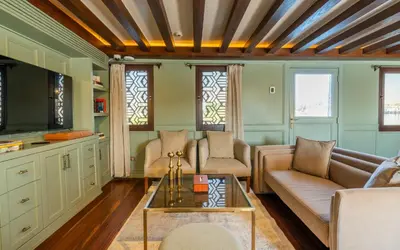 a living room with a couch and a table at HMC Zahra Dahabyia in Luxor