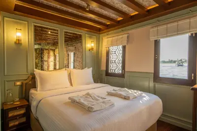 a bedroom with a large bed with towels on it at HMC Zahra Dahabyia in Luxor