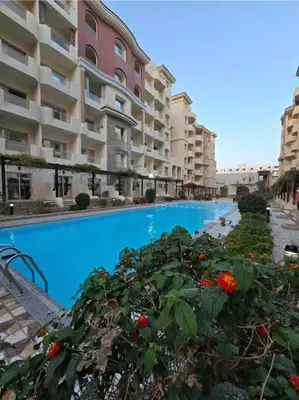 a view of the apartment complex from the swimming pool at Hurgada Florenza kamsen with pool view in Arabia area in Hurghada